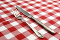 Tableknife and fork on red checked tablecloth Royalty Free Stock Photo