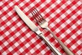 Tableknife and fork on red checked tablecloth Royalty Free Stock Photo