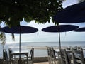 Tables and beach umbrellas by the sea at sundawn at Huahin , Thailand Royalty Free Stock Photo