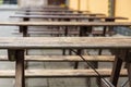 Tables and benches made of wood in the garden of the restaurant. Outdoor pub equipment Royalty Free Stock Photo