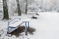 Tables and benches in the snow-covered city park. Royalty Free Stock Photo