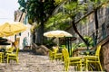 Tables of a cafe on the stairs of the old city in Montenegro Royalty Free Stock Photo