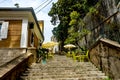 Tables of a cafe on the stairs of the old city in Montenegro Royalty Free Stock Photo