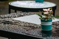 The tables in the cafe are on the street. Raindrops on the table after the cafe