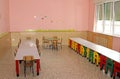 Tables and chairs in the dining hall of the school canteen in a Royalty Free Stock Photo