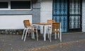 Tables and chairs in front of a store. Metal grilles at windows Royalty Free Stock Photo