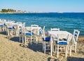 Table with chairs of a greek tavern. Kos, Greece. Royalty Free Stock Photo