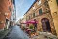 Tables and chairs in a narrow street