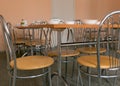 tables and chairs in the school dining room white bowls with lunch on the table