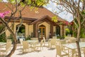 Tables and chairs setup for lunch at the outdoor restaurant at the tropical resort Royalty Free Stock Photo