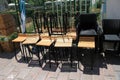 Tables and chairs stacked outside closed cafe-restaurant