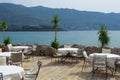 Tables and chairs of a street cafe without people near the sea. Montenegro. Budva Royalty Free Stock Photo