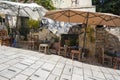 Tables, Chairs and Sun Umbrellas from a Restaurant Are Placed on the Street with a Steep Incline in the Plaka Area