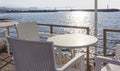 Tables with wooden chairs in traditional Greek tavern in Gouves town on coast of Crete island, Greece Royalty Free Stock Photo