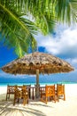 Tables and chairs at tropical beach restaurant Royalty Free Stock Photo