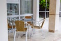 Tables and chairs with wicker seats in outdoor cafe Royalty Free Stock Photo