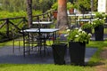 Tables, iron chairs and flower pots in garden (Greece) Royalty Free Stock Photo