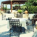 Tables and iron chairs on terrace and beautiful garden, Crete, G Royalty Free Stock Photo
