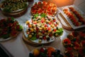 Tables in the restaurant with snacks and dishes. Easy food for guests. Business lunch. Preparing for wedding banquet. Smorgasbord