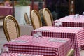 Tables on a restaurant terrace with a typical red checkered tablecloth Royalty Free Stock Photo