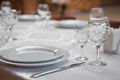 Tables set for meal . fork, knife . empty glasses and plates on the table in the restaurant Royalty Free Stock Photo