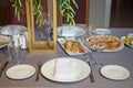 Tables set for meal . fork, knife , table towel . Pizza, potato fries. empty glasses and plates on the table in the restaurant Royalty Free Stock Photo