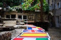 Tables in street cafe, painted in colors of flags of different countries Spain, United Kingdom, France. Terrace.