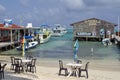 Tables with umbrellas on the beach on Ambergris Key Royalty Free Stock Photo