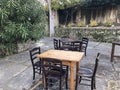 Tables with vintage chairs in a pub garden in a medieval village
