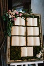 Tables wedding guests on the easel on wedding reception. The frame is decorated with green flowers and greenery. List, plan, chart Royalty Free Stock Photo