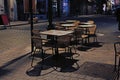 Tables and wicker chairs of an evening street cafe Royalty Free Stock Photo