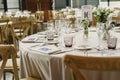Tables and wooden chairs arranged and decorated in a wedding hall of a hotel Royalty Free Stock Photo