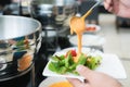 Tablespoon measure of creamy thousand island dressing being pour