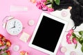 Tablet, alarm clock, underwear, roses, candles, cosmetics on the table. Women`s things Fashion womens desk