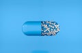 Tablet on the background. Blue tablet with granules. The cure for the virus. Royalty Free Stock Photo