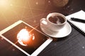 Tablet and black coffee on wooden table with Digital Earth world Royalty Free Stock Photo