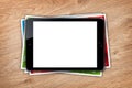 Tablet with blank screen and stack of printed pictures collage Royalty Free Stock Photo