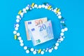 Tablet blisters and Euro banknote. Spending money on pills and expensiveness of medicine concept