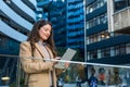 Tablet, business woman and research in city, typing or reading email notification to network. Digital, technology and professional