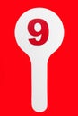 Nameplate with number 9 isolated on the red background