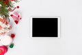 Tablet christmas composition. cones and christmas decorations on white background. flat lay top view. Royalty Free Stock Photo