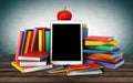 Tablet, colorful books, school supplies and an apple Royalty Free Stock Photo