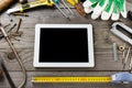 Tablet computer with a blank screen with old tools Royalty Free Stock Photo