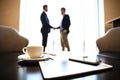 Tablet computer, coffee and smartphone with businessmen handshaking on background Royalty Free Stock Photo