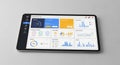 Tablet computer displaying business analytics dashboard with various charts and graphs on screen for data analysis Royalty Free Stock Photo