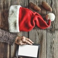 Tablet computer in the human hands. Near the table with tablet computer gift boxes, christmas bell and fluffy fir branches. Free s Royalty Free Stock Photo