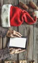Tablet computer in the human hands. Near the table with tablet computer gift boxes, christmas bell and fluffy fir branches. Free s Royalty Free Stock Photo