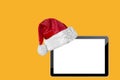 a tablet computer isolated with a Santa Claus hat for Christmas Royalty Free Stock Photo