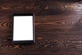 Tablet computer on the old wooden boards. White screen