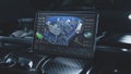 Tablet computer screen shows 3D visualization of car diagnostics software